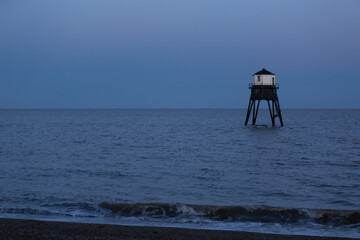 Lighthouse in the sea, Dovercourt low lighthouse at high tide built in 1863 and discontinued in 1917 and restored in 1980 the 8 meter lighthouse is still a iconic sight after sunset