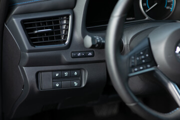 Cruise control, speed limit and volume buttons on modern car steering wheel, interior details....