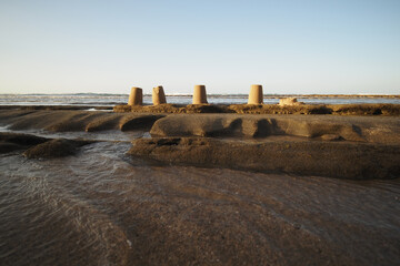 Sand sculptures on the rocks near the Ocean.