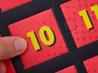 A woman hand ready to open the door with number 10 on the advent calendar.