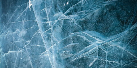 Abstract natural ice texture. Freezy ice surface. Blue backdrop with cracks and scratches on frozen...