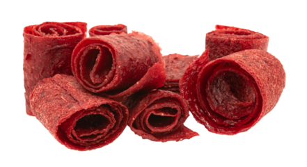 Pastille rolls. Fruit peel in pieces. Raw food diet, vegan sweets, dessert without sugar and flour. Red fruit rolls on a white background. Healthy eating