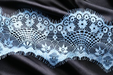 Light blue lace on black fabric, top view