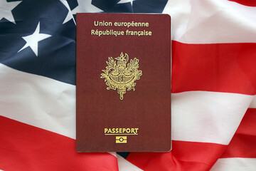 French passport on United States national flag background close up. Tourism and diplomacy concept
