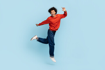Man jumping in excitement on blue background