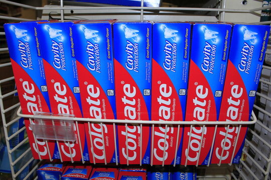 Colgate tooth paste in boxes on a shelf