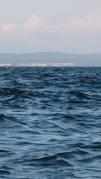 Continuously changing, disquiet sea surface in the Kvarner Bay, Croatia. Beautiful, deep blue wavy water on a windy spring afternoon. Refreshing, abstract and minimalistic footage.