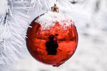 red christmas ball covered with snow
