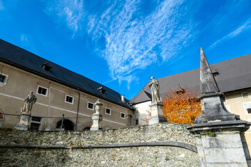 Exterior view of Benedictine monastery Saint Lambrecht Abbey in nature reserve Grebenzen, Styria, Austria. Religious landmark with rich and unique architect features. Travel destination. Sightseeing - obrazy, fototapety, plakaty