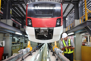  Engineer or Professional technician  railroad tracks of electrical or sky train in factory workplace. Maintenance plant of Sky Train.
