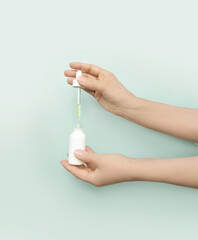 woman applying serum, lotion to her face