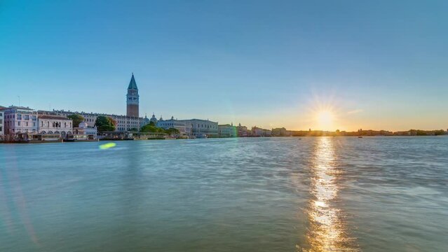 Beautiful sunrise at Grand canal over San Marco square timelapse. Panoramic view from Church of Santa Maria della Salute, Venice, Italy, European Union. Famous historical heritage. Reflection on water