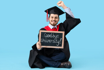Male graduate student holding chalkboard with text GOODBYE UNIVERSITY on blue background