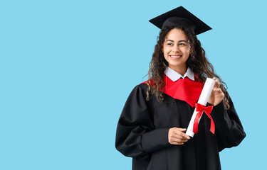 African-American female graduate student with diploma on blue background