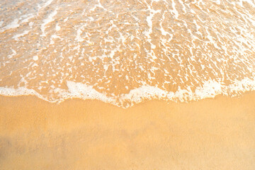Fototapeta na wymiar Beach sand and sea wave with foam, beach background