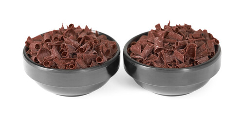 Delicious chocolate shavings in bowls isolated on white