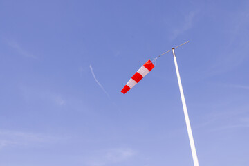 Photo of a wind sock with wind blowing through the sleeve on a clear blue sky sunny day taken in...