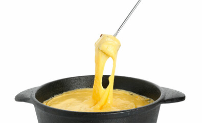 Dipping piece of bread into fondue pot with tasty melted cheese isolated on white
