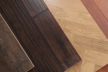 Different samples of wooden flooring as background, top view