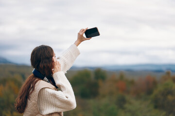 Mountain Adventure: A Smiling Woman Embracing Freedom and Nature, Capturing a Selfie in Cyberspace
