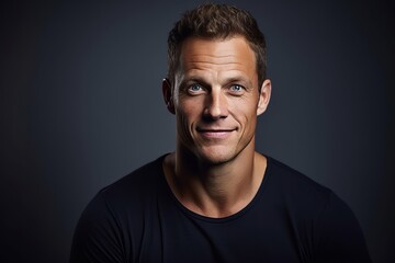 Obraz premium Portrait of a handsome young man on dark background. Men's beauty, fashion.