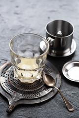 Condensed milk in a glass and phin for vietnamese coffee on metal tray - 774413034