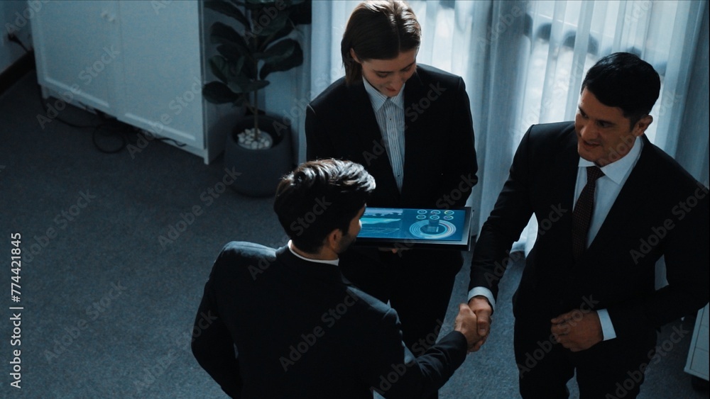 Poster top down aerial view of smart manager standing with diverse team and analyze financial data from tab