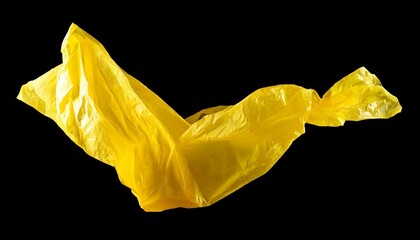 Yellow plastic film floating in front of a black background.