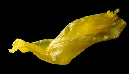 Yellow plastic film floating in front of a black background.