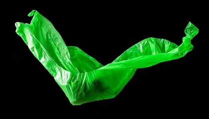 Green plastic film floating in front of a black background.