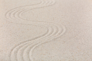 Fototapeta na wymiar Sand with lines in Japanese rock garden. Zen concept