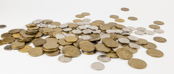 Scattered table coins, Ukrainian national currency, hryvnia. The concept of putting away baskets for old age.