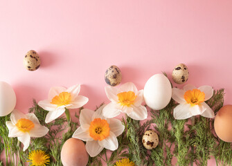 Creative arrangement made of spring flowers, eggs, radishes and dill on pastel pink base. Minimal...