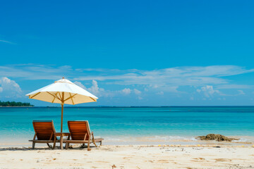 Two beach chairs on the tropical sand beach.