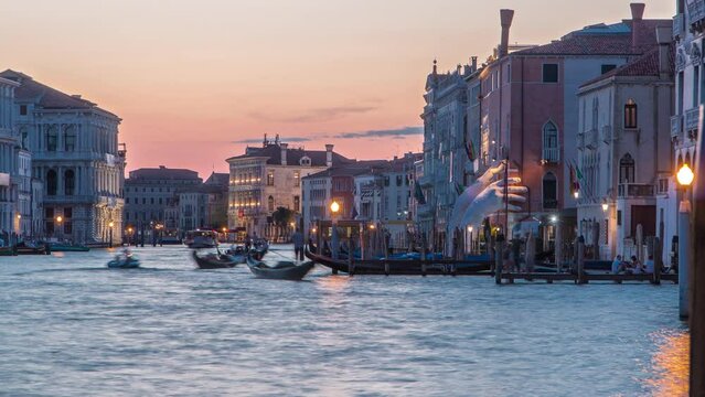 Grand canal with gondolas near Rialto Market day to night transition timelapse after sunset, San Polo, Venice, Italy viewed from pier at summer