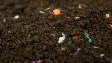 Microplastics inside the soil. Concept of plastic pollution, fertilizing and agro industry....
