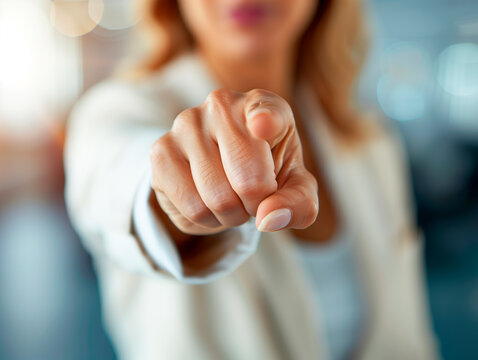 A woman firmly points her finger straight ahead. Concept of empowerment, leadership and bravery.
