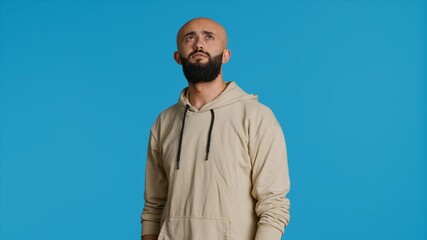 Muslim person looking at information on a hologram, trying to create new slideshow with holographic projection on artificial intelligence metaverse. Young adult using holograph image. Camera 1.