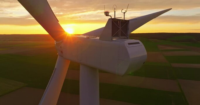 Establishing shot of windmills farm. Power energy production. Wind turbines. Large wind turbines with blades in field aerial view, sunset