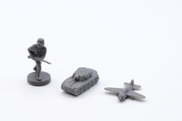Gray war toys. Plastic soldier, tank and airplane. WW2 concept. White background.