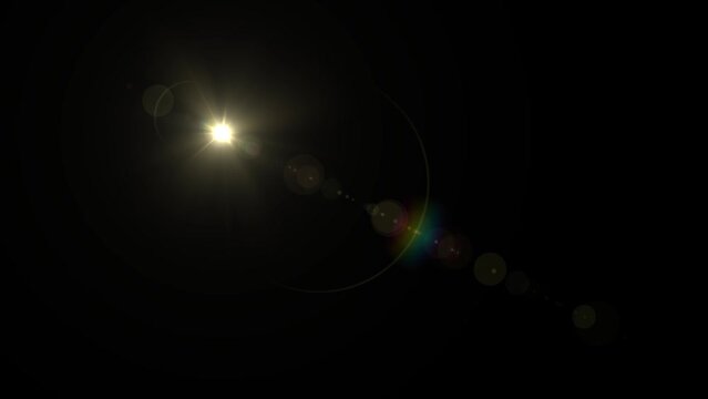 Optical Lens flare effect on black background. Sunset in space. Anamorphic lens effect in yellow tone, 4K video. The sun moves slowly from top left corner to bottom right corner.