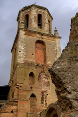 Fototapeta na wymiar San Tirso church and the San Benito Monastery tower in the way of Santiago, Sahagun, León, Castilla y Leon, Spain.