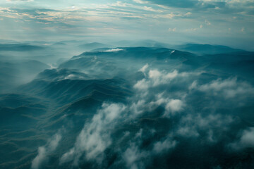 an aerial view of a foggy morning over a forest or mountain