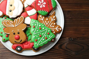Different tasty Christmas cookies on wooden table, top view. Space for text