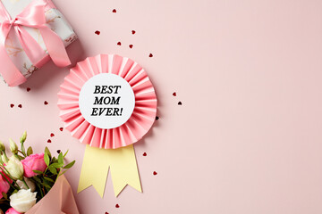 Best mom ever rosette, gift box, bouquet of flowers, confetti on pastel pink background. Top view....