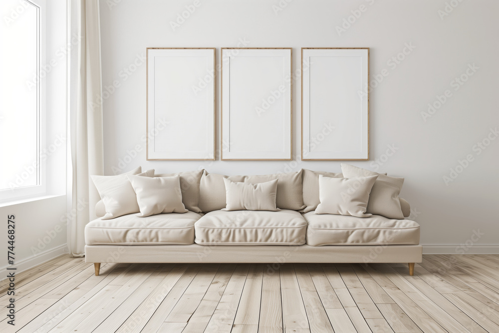 Poster a white couch with three empty frames on the wall.
