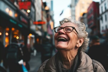 Portrait of happy senior woman with eyeglasses in the city - obrazy, fototapety, plakaty