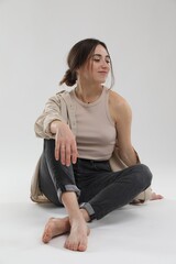Fototapeta premium Portrait of beautiful woman on light grey background