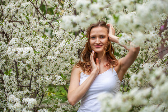 Young beautiful woman in a blooming garden