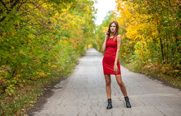 Fashion portrait of a young beautiful woman in red dress